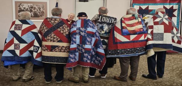 A group of people wearing blanketsAI-generated content may be incorrect.