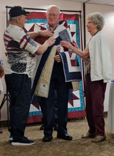 A group of people standing in a roomAI-generated content may be incorrect.