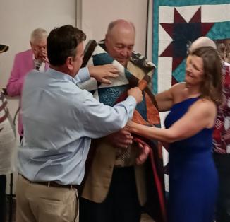 A group of people holding blanketsAI-generated content may be incorrect.