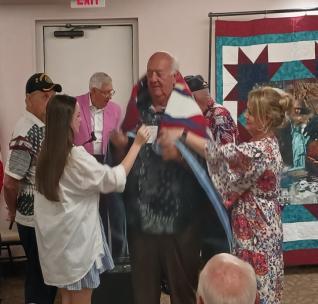 A group of people standing around a personAI-generated content may be incorrect.